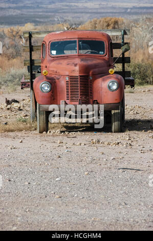 Front view of an old abandoned red truck on an empty lot in New Mexico, NM, USA. Stock Photo