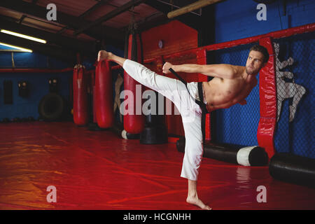 Karate player practicing kickboxing Stock Photo
