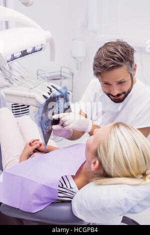 Dentist showing x-ray to the patient Stock Photo