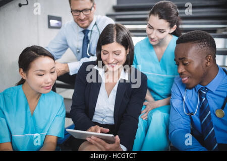 Doctors and nurse looking at digital tablet Stock Photo