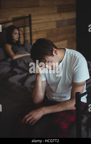 Upset couple ignoring each other after fight on bed Stock Photo