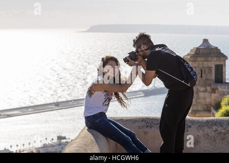 Santa Barbara Castle, Castell de la Santa Bàrbara, Alicante, Spain, young couple taking photographs and posing Stock Photo