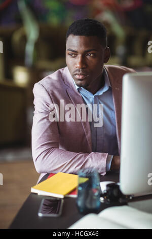 Thoughtful businessman looking away Stock Photo