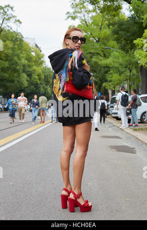 Woman with red high heel shoes before Fendi fashion show, Milan Fashion Week street style on September 22, 2016 in Milan. Stock Photo