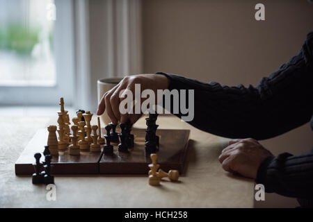 Man playing chess at home Stock Photo