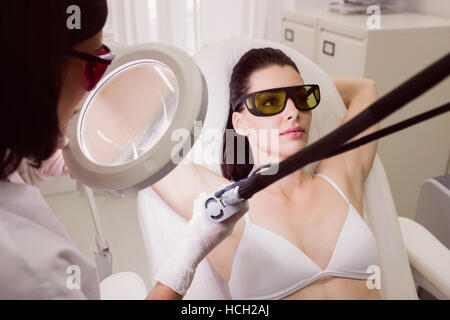 Female patient receiving laser hair removal treatment Stock Photo