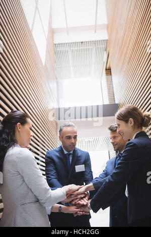 Businesspeople stacking hands together Stock Photo