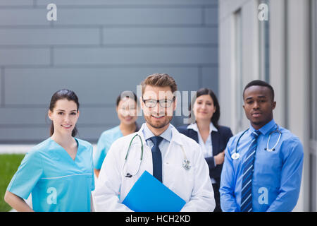 Team of doctors standing together in hospital premises Stock Photo