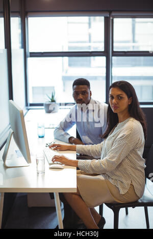 Businessman and a colleague working over computer Stock Photo
