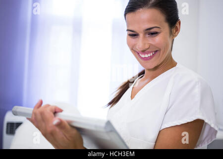 Smiling dentist using digital tablet Stock Photo