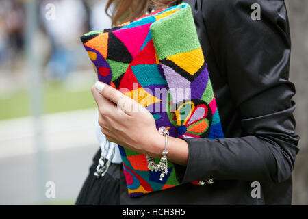 Woman with colorful fabric bag before fashion Tod's show, Milan Fashion Week street style on September 23, 2016 in Milan. Stock Photo