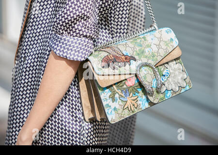Woman with Gucci bag with floral decoration before Giorgio Armani fashion  show, Milan Fashion Week street style on September 23 Stock Photo - Alamy
