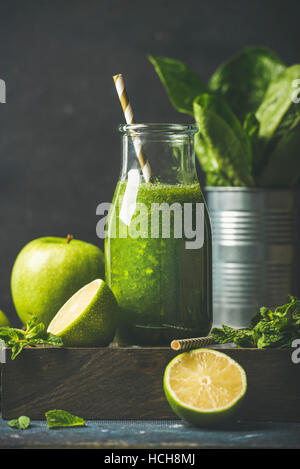 Green smoothie in glass bottle with apple, romaine lettuce, lime and mint, dark background, selective focus. Detox, dieting, clean eating, vegetarian, Stock Photo