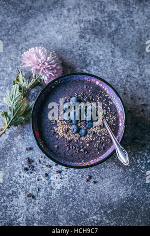 Blueberry acai banana smoothie bowl topped with bluberries, sesame seeds and cacao nibs Stock Photo