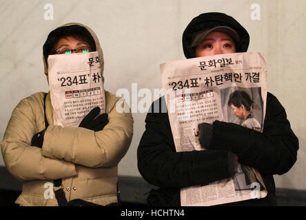 Seoul, South Korea. 9th Dec, 2016. South Korean people carry newspaper reading 'The approving impeachment of president Park Geun-Hye ' during the rally against President Park Geun-Hye on the Gwanghwamun square. Credit:  Min Won-Ki/ZUMA Wire/Alamy Live News Stock Photo