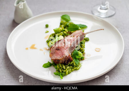 Green risotto with romanesco cauliflower,  parmesan and lamb Stock Photo