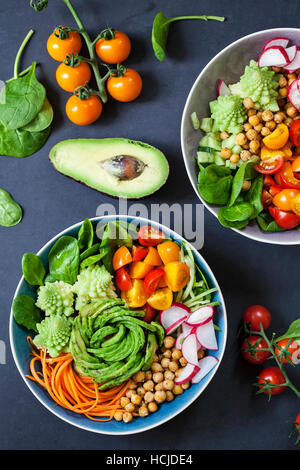 Buddha vegetable bowl with avocado, romanesco cauliflower, carrots, chickpeas, tomatoes and radishes Stock Photo