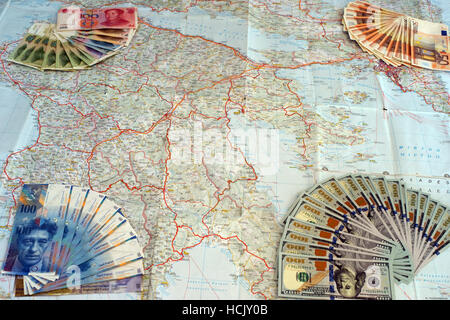 Euro, yuan, us dollars and swiss frank banknotes on map of Greece. Symbolize greek default and foreign interests.
