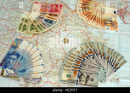 Euro, yuan, us dollars and swiss frank banknotes on map of Greece. Symbolize greek default and foreign interests.