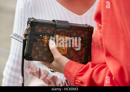 MILAN - SEPTEMBER 23: Woman with black Louis Vuitton bag with pink