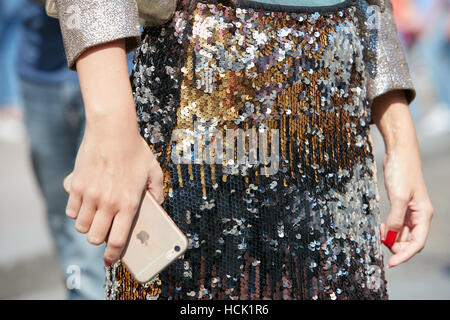 Woman with golden, silver and black sequins pattern before Stella Jean fashion show, Milan Fashion Week street style, in Milan.