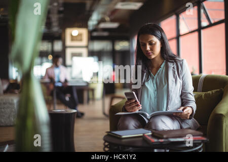 Businesswoman using mobile phone Stock Photo