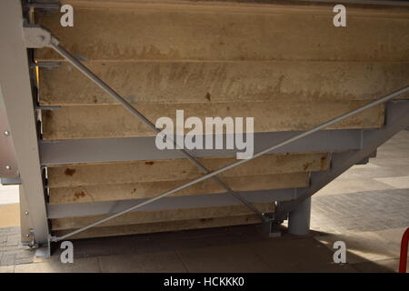 Underneath a wooden and metallic flight of stairs Stock Photo