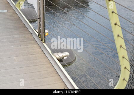 Perforated Bricks Railing An orange metal railing construction detail with hand holding red paint ...