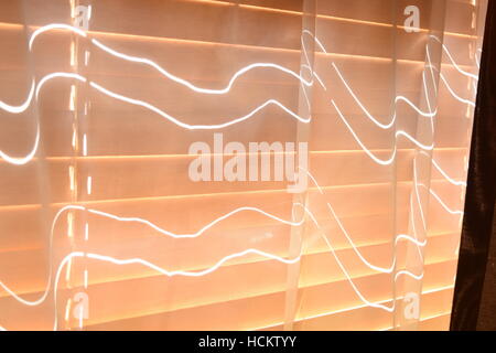 Thin strips of light shining through the gaps in the wooden shutters Stock Photo