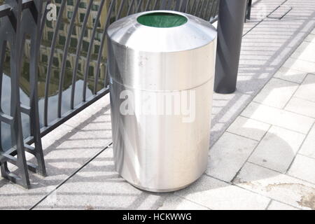 Small metallic trash bin in a modern city district Stock Photo