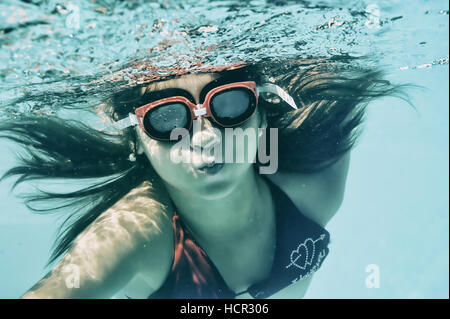 Little girl swimming underwater in sea