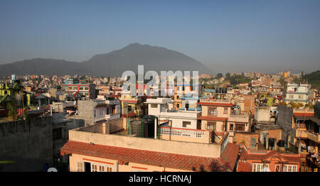 Roof tops of the city of Kathmandu on a sunny day with mountains in the background, Nepal. Stock Photo