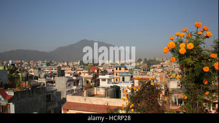 Roof tops of the city of Kathmandu on a sunny day with mountains in the background, Nepal. Stock Photo