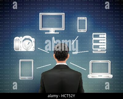 businessman stands in front of multimedia icons over blue background Stock Vector