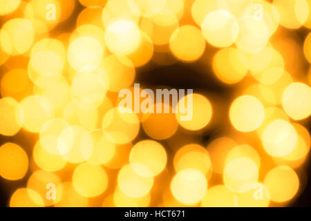 Christmas lights gold blurred lights on black background. Stock Photo