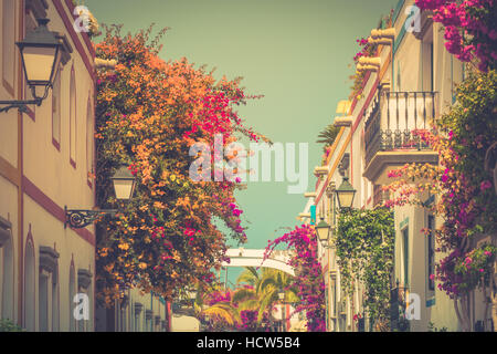 Colourful alley in the harbor area of Puerto de Mogan, a small fishing port in Gran Canaria, Canary Islands, Spain Stock Photo