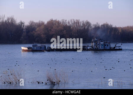 A  shoal-draft flat-bottomed barge on the Danube river in the city of Belgrade capital of the Republic of Serbia Stock Photo