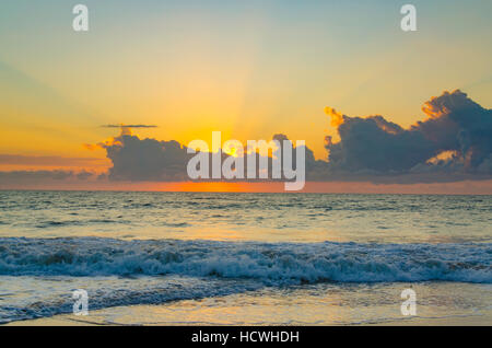 The morning sun beams over the clouds as it rises on the eastern coast of Australia Stock Photo