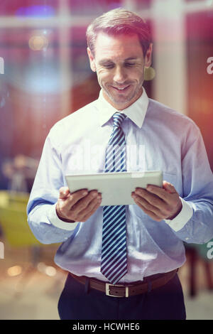 Happy businessman using digital tablet Stock Photo