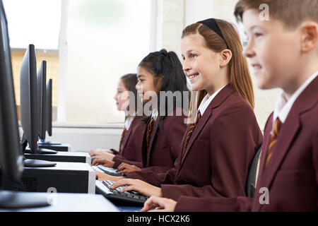 Pupils Wearing School Uniform In Computer Class Stock Photo