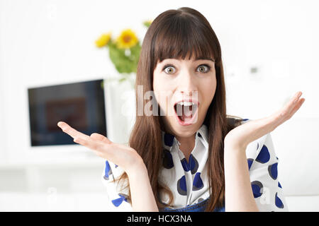 Young Woman Making Shocked Gesture With Hands Stock Photo
