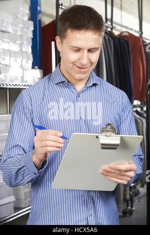 Businessman Running On Line Fashion Business With Clipboard Stock Photo