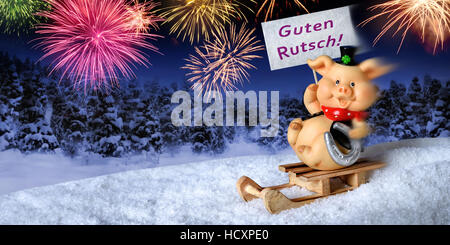 Lucky pig on a sleigh holding a sign saying 'Guten Rutsch', German for 'Happy New Year', with fireworks in the night sky Stock Photo
