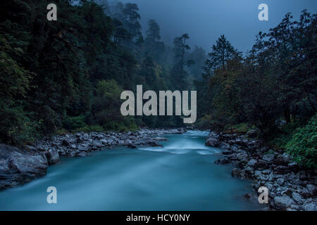 Langtang Khola near the little village of Riverside on a misty evening in the Langtang region of Nepal Stock Photo