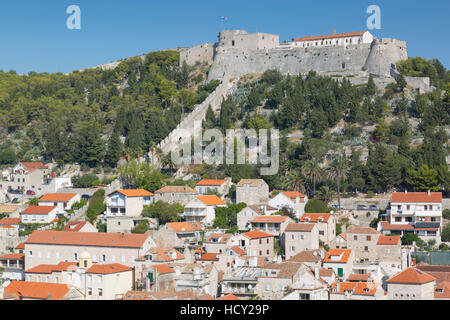 View of Hvar Main Square overlooked by Spanish Fortress, Hvar, Hvar Island, Dalmatia, Croatia Stock Photo