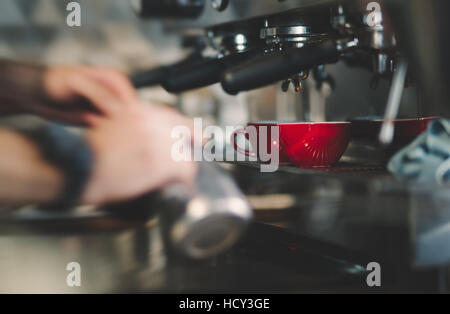 Espresso coffee made by barista and machine Stock Photo