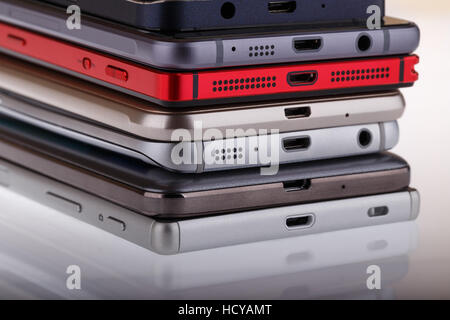 Pile of mobile phone. Heap of the different smartphones on white background. Stock Photo
