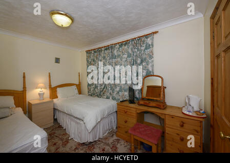 A budget bed and breakfast bedroom in the UK Stock Photo