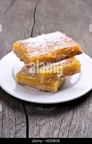 Lemon squares on white plate, homemade baking Stock Photo