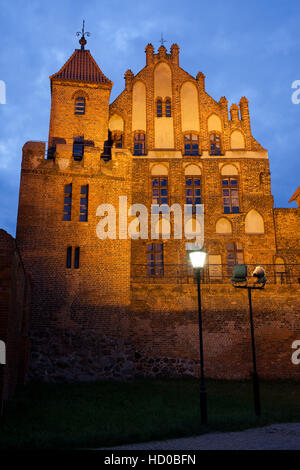 Citizen Court and sentry tower at night in Torun, Poland, former summer residence of the Brotherhood of St. George, medieval Gothic architecture, 13-1 Stock Photo